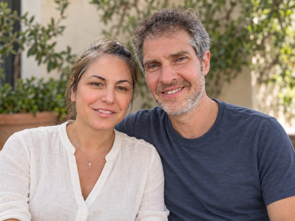 Jennifer Denmark and Tim Ellison sitting together outdoors, smiling