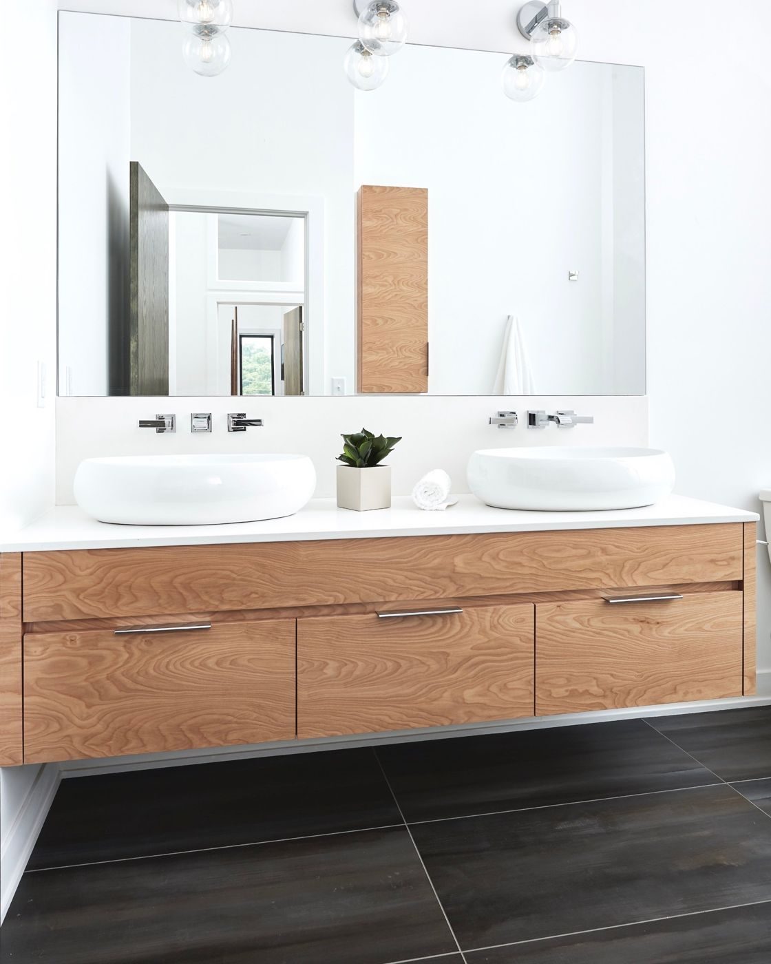 New bathroom with a floating wood vanity and two vessel sinks